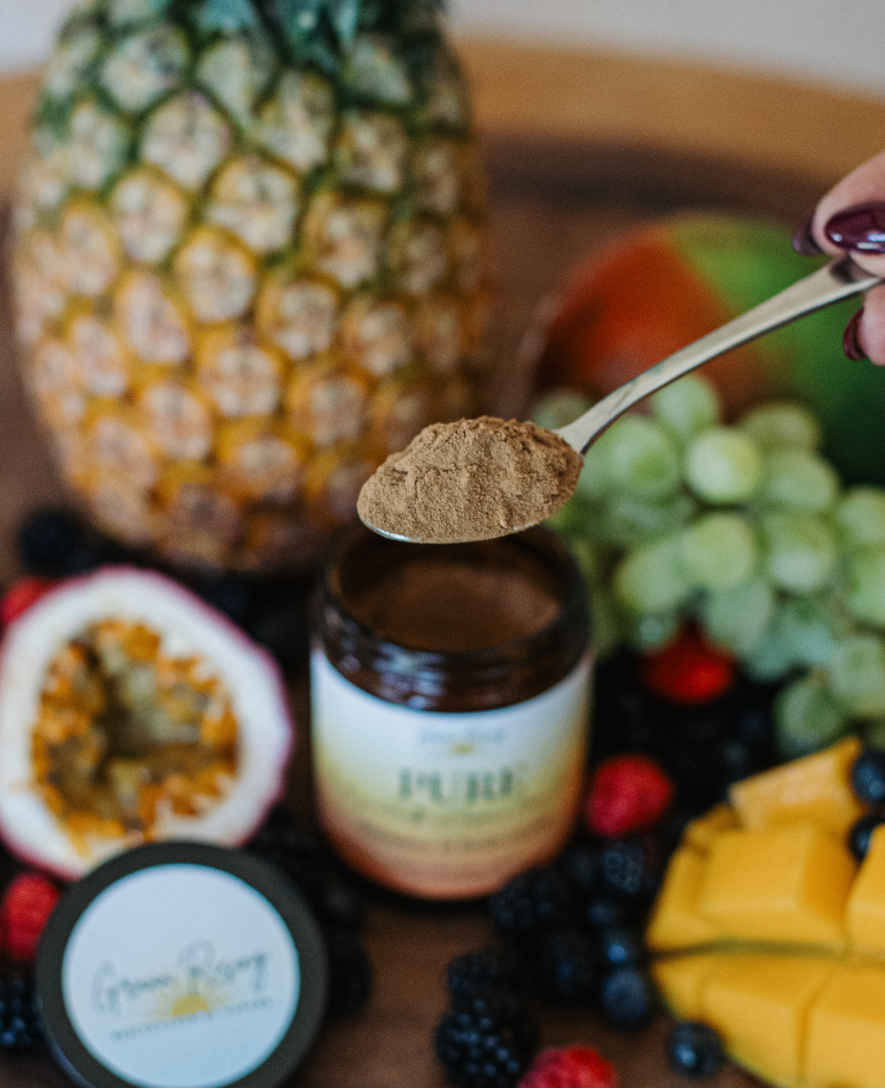 A wooden spoon holding a scoop of Grann Rising mushroom blend powder